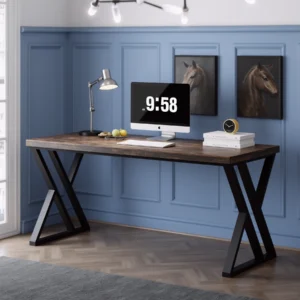 Office desk with X-frame legs in rustic wood finish, set against a blue panel wall