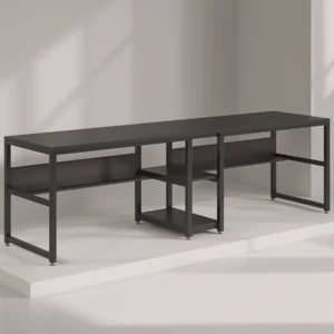 Minimalist black metal double computer desk on a white display platform, with open shelves for storage.