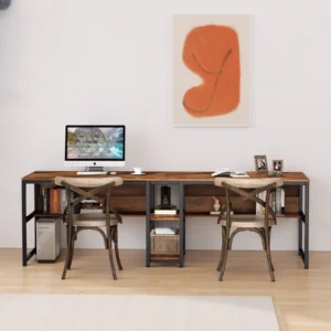 Rustic industrial double desk with wooden surface and black frame, styled with modern chairs and orange abstract art.