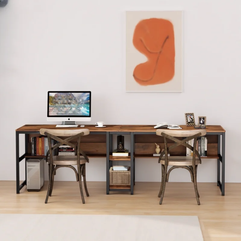 Rustic industrial double desk with wooden surface and black frame, styled with modern chairs and orange abstract art.