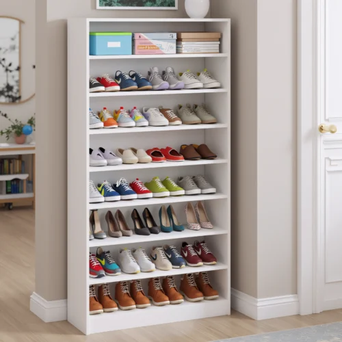 White shoe cabinet filled with assorted shoes in a bright hallway