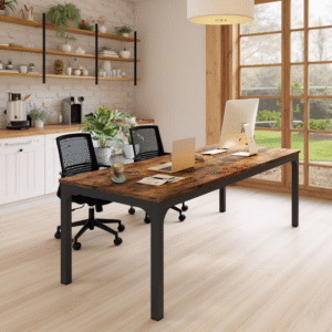 Two-person rustic desk in a cozy home office with warm wood flooring and garden view